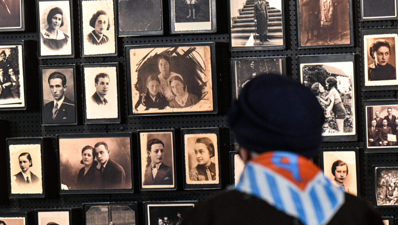 Auschwitz survivor, Zdzislawa Wlodarczyk, walks towards the podium full of portraits at the former Nazi-German concentration and extermination camp Auschwitz II-Birkenau during the 78th Anniversary of Auschwitz Liberation on January 27, 2023 in Oswiecim, Poland.
