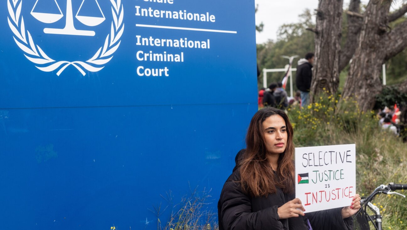 A pro-Palestinian demonstrator holds a sign that reads “Selective Justice is Injustice” during a pro-Palestinian demonstration in front of the International Criminal Court in The Hague, Oct. 18, 2023. (Roger Anis/Getty Images)