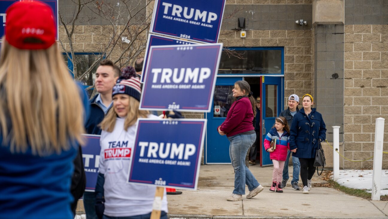 People exit a polling center at Londonderry High School as Trump supporters rally outside, in Londonderry, New Hampshire, Jan. 23, 2024. (Brandon Bell/Getty Images)