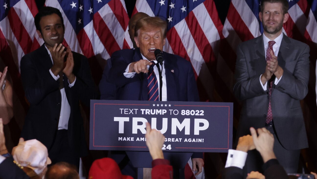 Republican presidential candidate and former U.S. President Donald Trump delivers remarks alongside supporters, campaign staff and family members during his primary night rally at the Sheraton in Nashua, New Hampshire, Jan. 23, 2024. (Alex Wong/Getty Images)