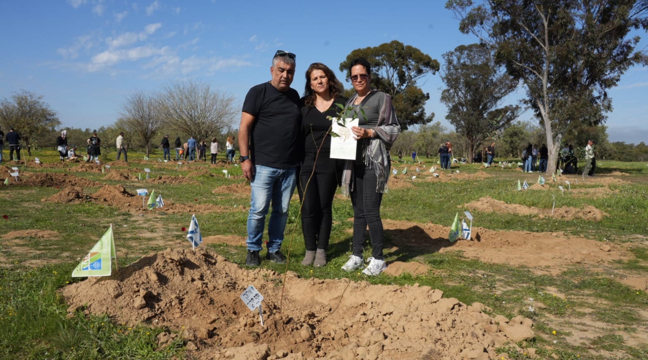 KKL-JNF Chair Ifat Ovadia-Luski with Doron and Meirav Madar, the parents of Shahak Yosef Madar, who was killed on Oct. 7, plant eucalyptus trees in honor of the victims of the Re’im massacre. (Yossi Ifergan/KKL-JNF Archive)