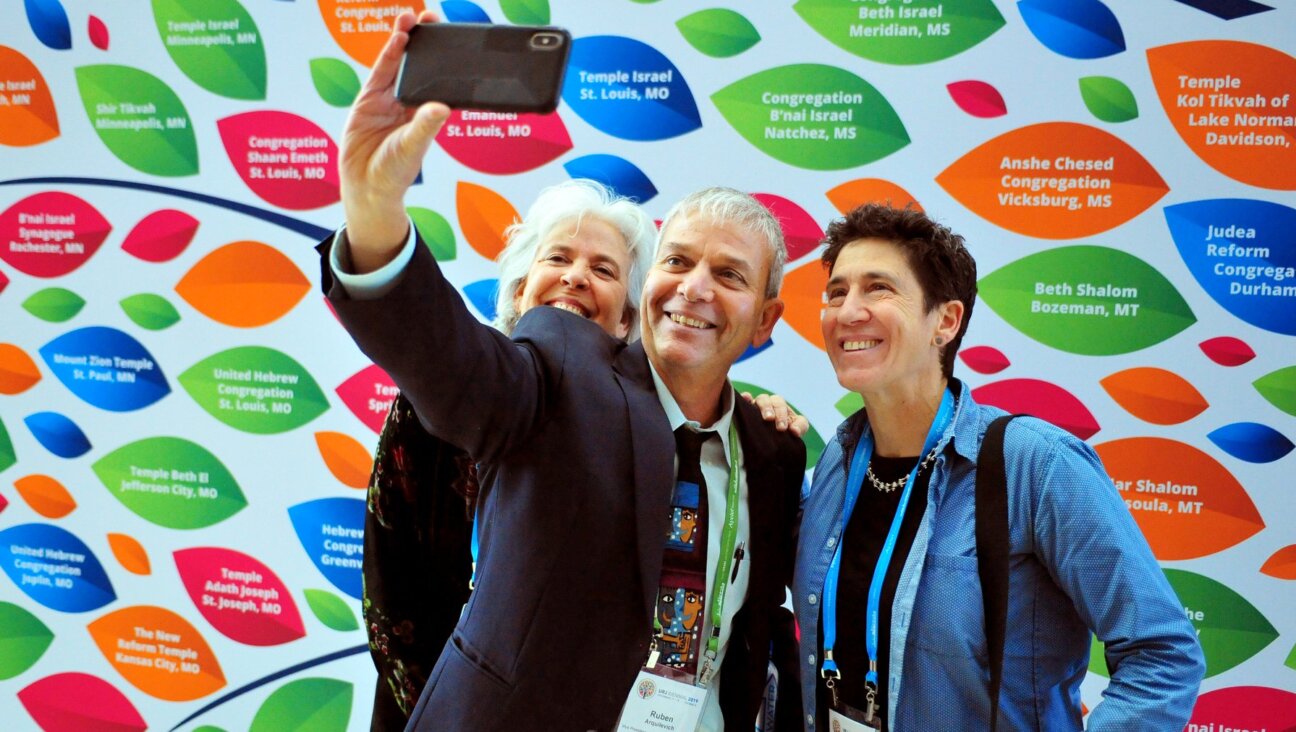 Participants at the Union for Reform Judaism's 2019 convention in Chicago pose in front of a photo backdrop. The congregational arm of the Reform movement unveiled a new logo and visual brand earlier this month.