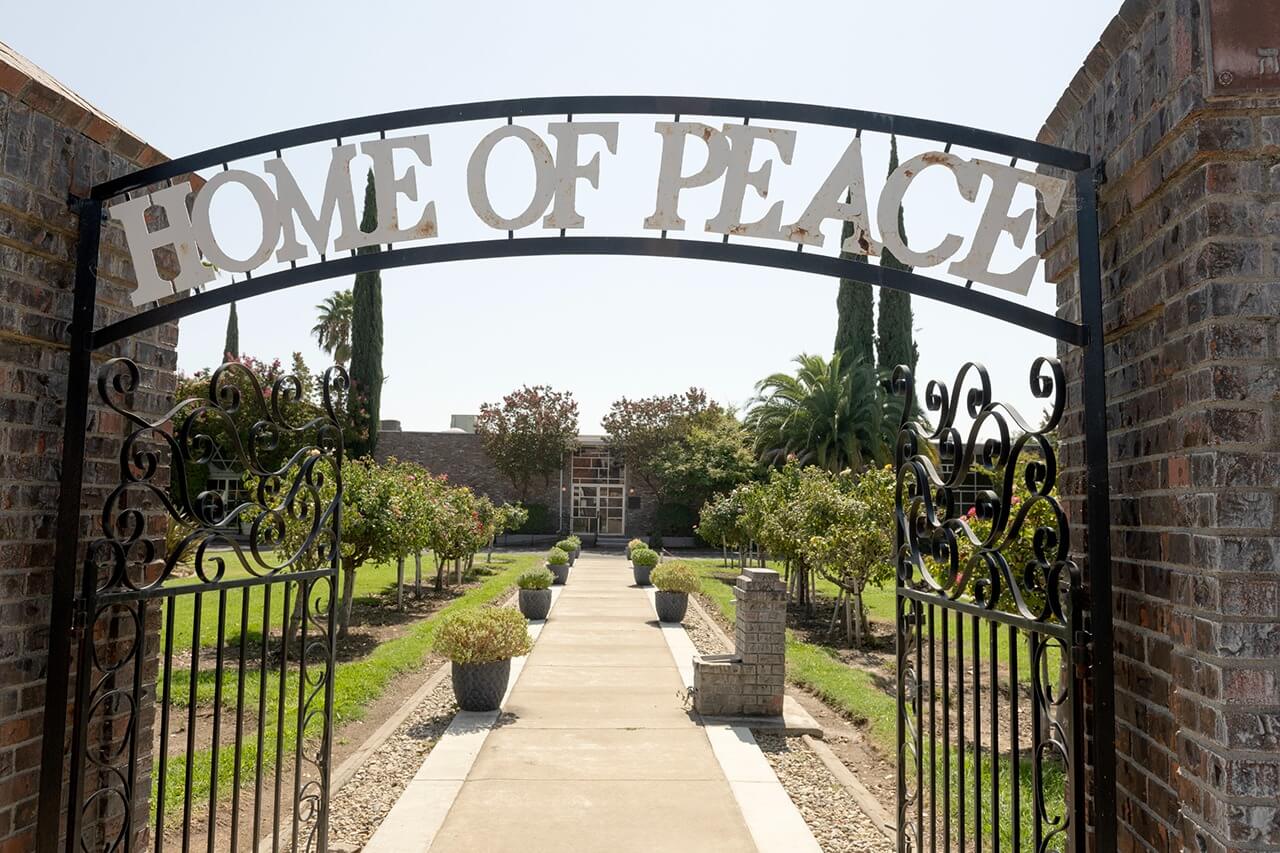 The entrance to Home of Peace Jewish cemetery in Sacramento is marked with rose bushes.