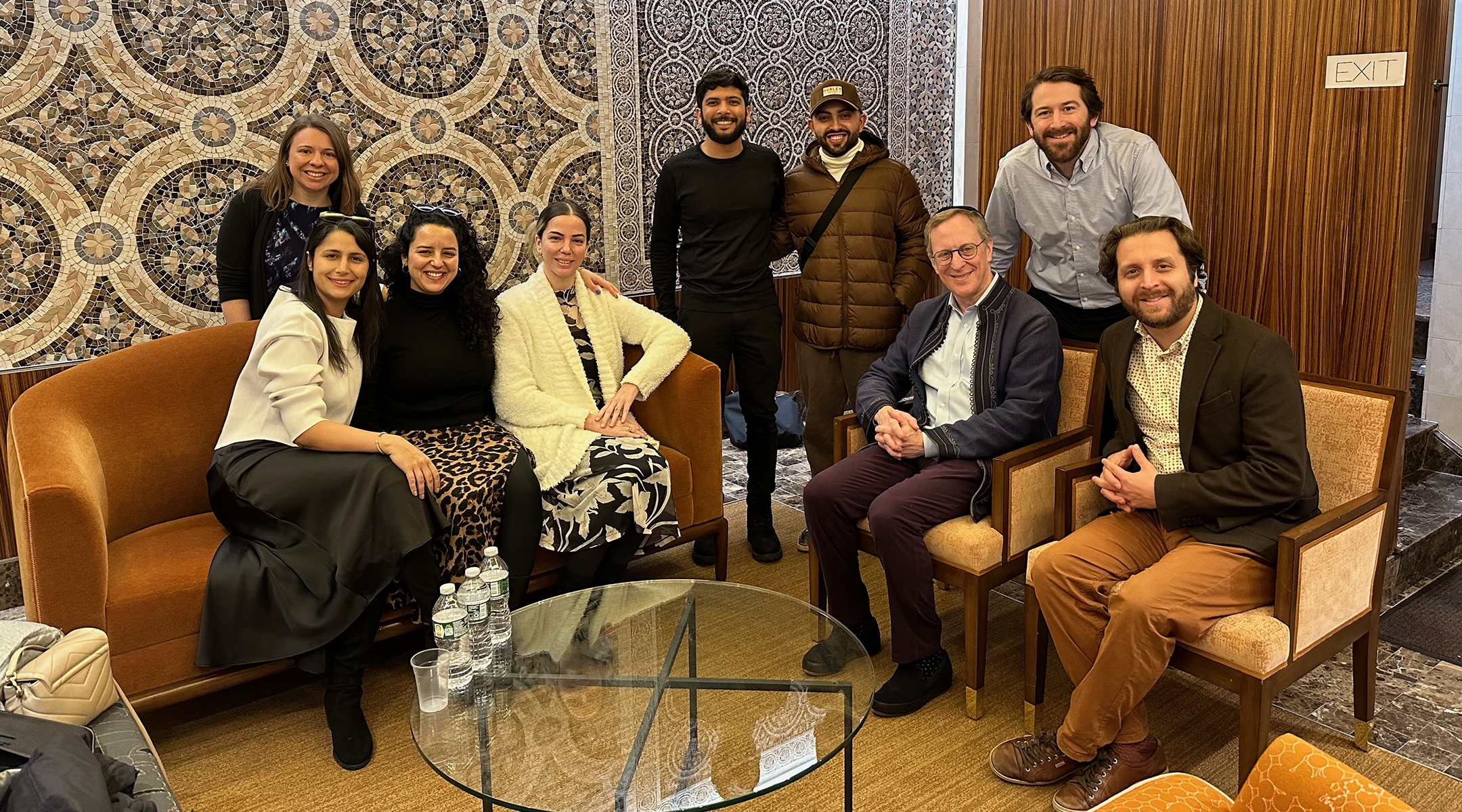 Members of a conversion program meeting in New York City on Dec. 21, 2023. Jasamine Hodge is seated in the center in a white sweater, with her fiancé Adir standing to her left. Seated on the right are Rabbis Adam Mintz and Avram Mlotek. (Courtesy of Hodge)