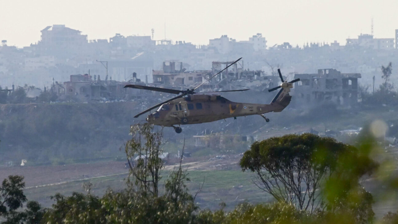 A military helicopter flying above the Gaza Strip, as it seen from the Israeli side of the border, on Jan. 8, 2024. (Tomer Neuberg/Flash90)