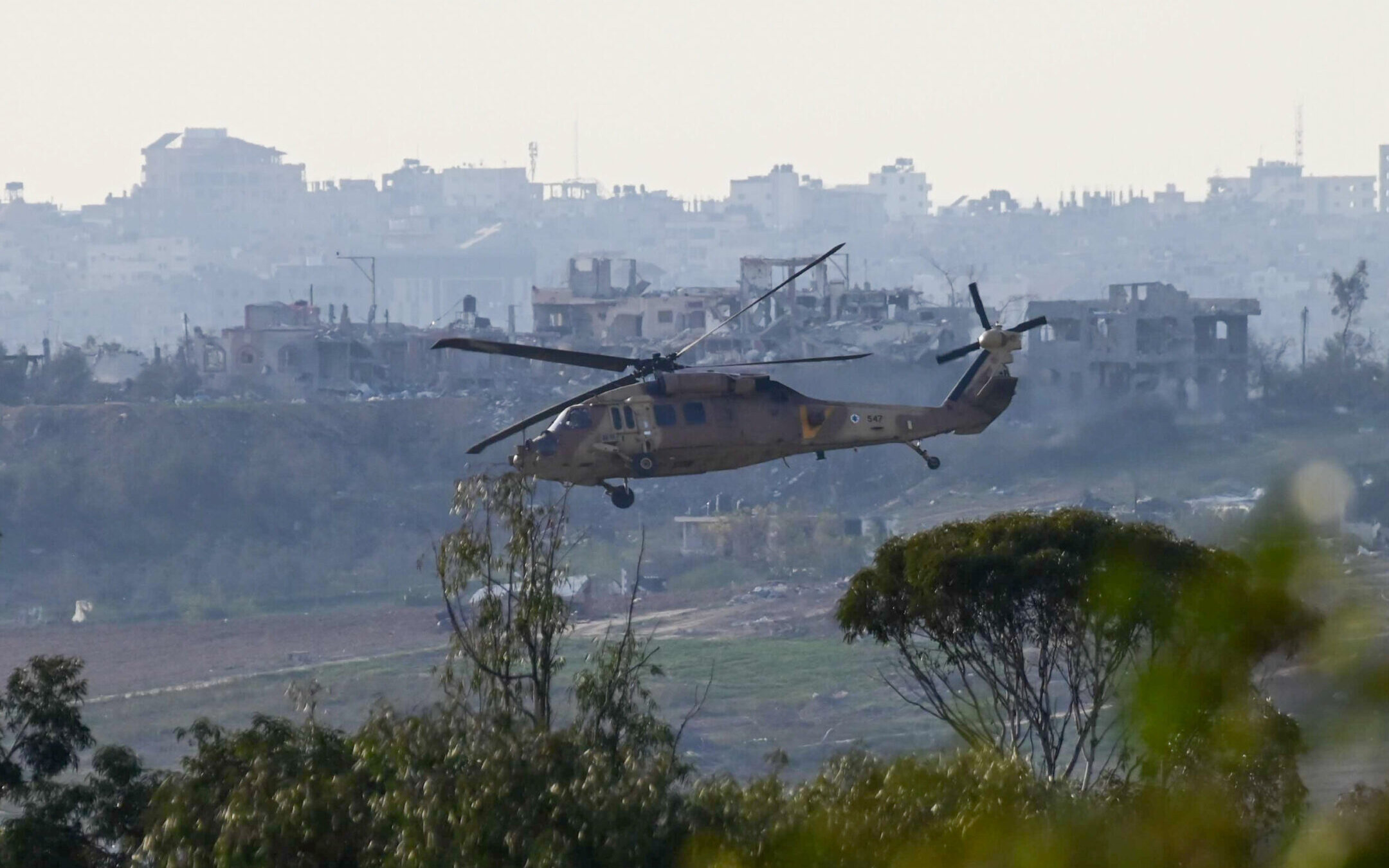 A military helicopter flying above the Gaza Strip, as it seen from the Israeli side of the border, on Jan. 8, 2024. (Tomer Neuberg/Flash90)