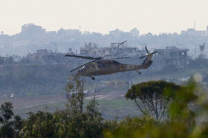 A military helicopter flying above the Gaza Strip, as it seen from the Israeli side of the border, on Jan. 8, 2024. (Tomer Neuberg/Flash90)