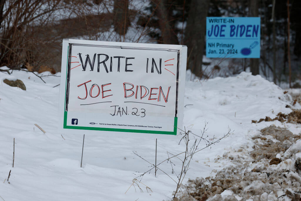Campaign signs on Jan. 19, 2024 asking voters to write in President Joe Biden in Tuesday's primary. 