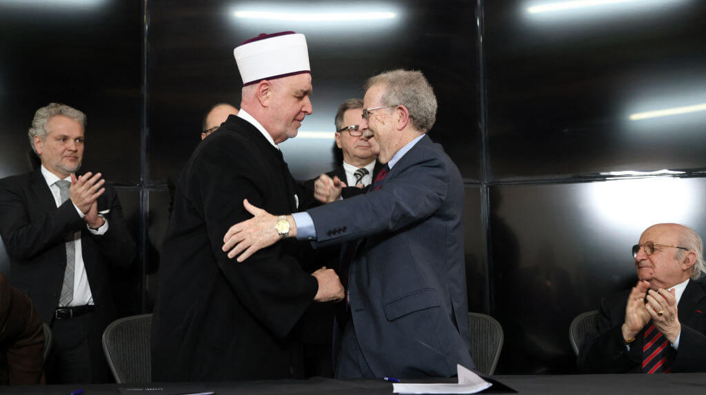 The President of the World Federation of Bergen-Belsen Associations, Menachem Rosensaft, right, and the religious leader of Bosnian Muslims, Husein Kavazovic, embrace after signing a "Jewish-Muslim Initiative for Peace" at the Srebrenica Genocide Memorial Centre in Srebrenica, on January 27, 2024, on International Holocaust Remembrance Day.