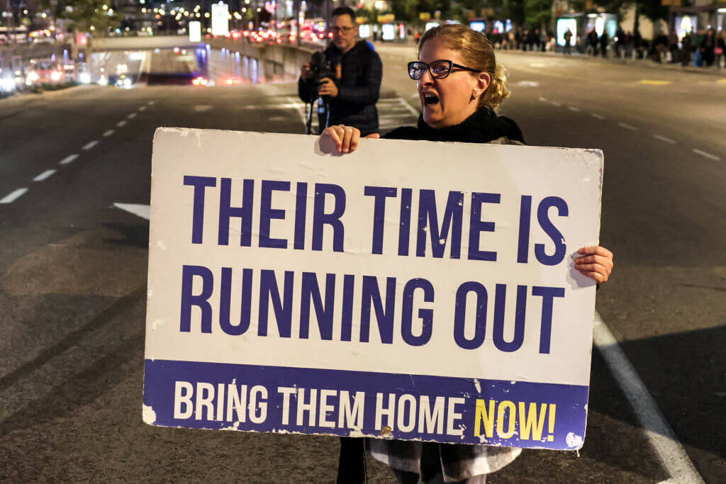 Families of Israeli hostages held in Gaza gather with supporters for a demonstration demanding an immediate deal as they block off a road in Tel Aviv on January 29, 2024.