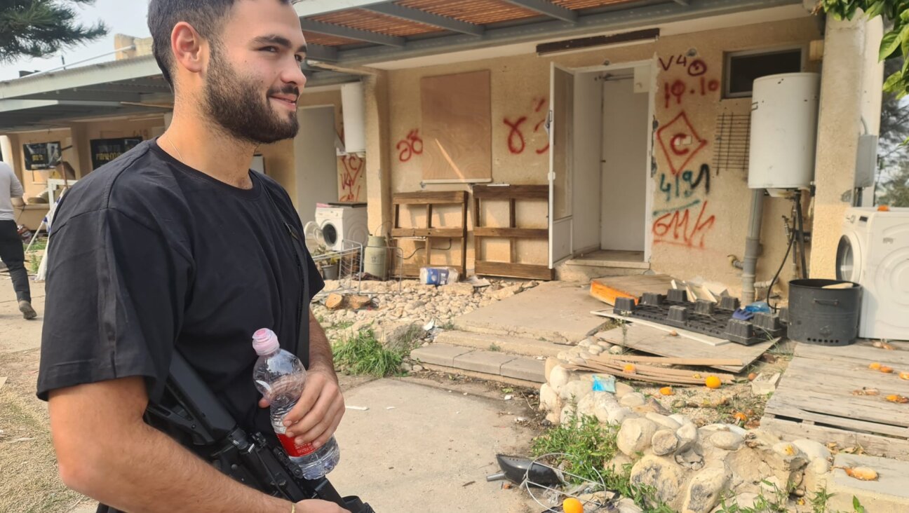 Ido Felus stands outside the wreckage of his home at Kibbutz Kfar Aza, which was devastated by Hamas terrorists on Oct. 7, in January 2024. He believes returning to the kibbutz is essential for Israel’s future. (Deborah Danan)