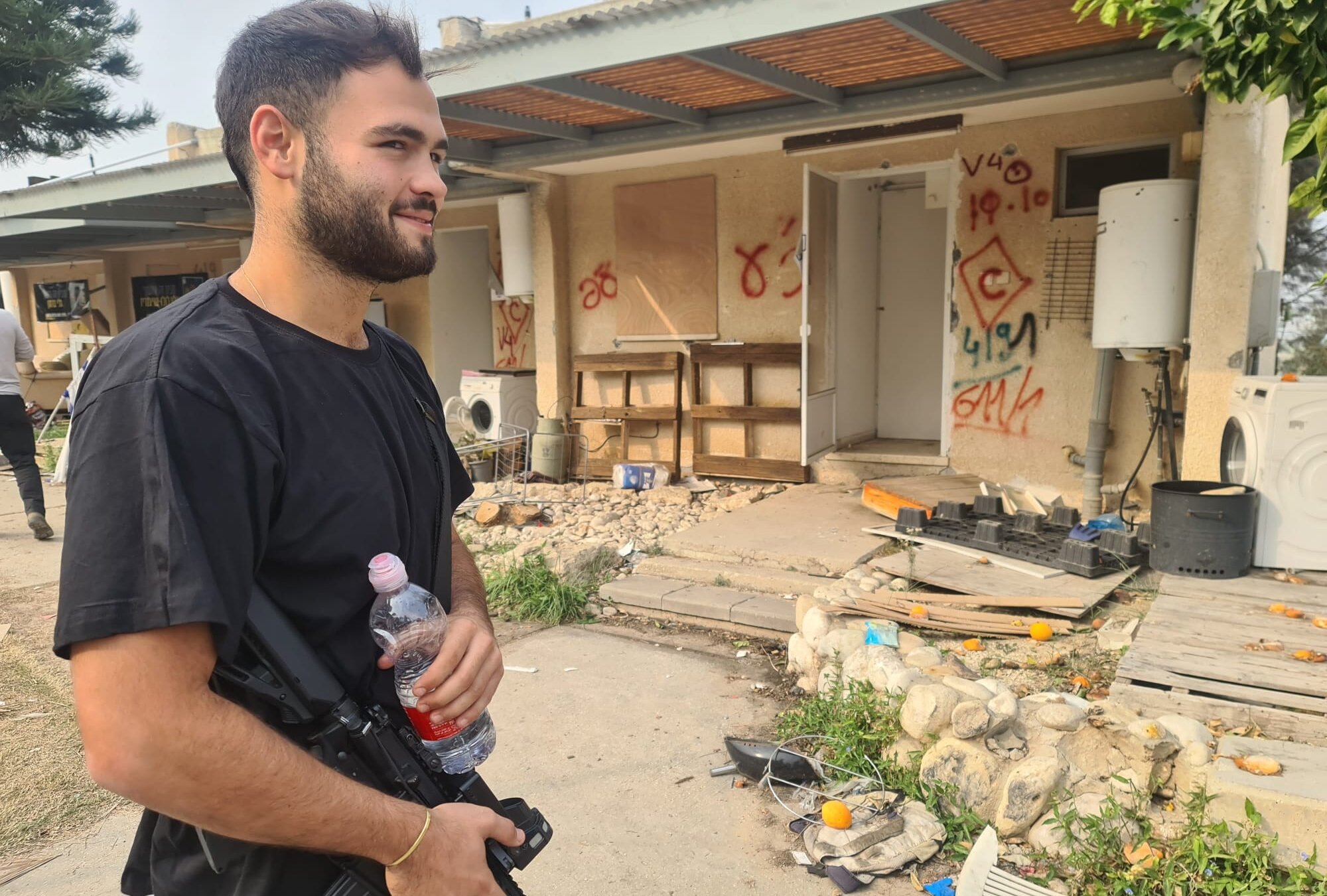 Ido Felus stands outside the wreckage of his home at Kibbutz Kfar Aza, which was devastated by Hamas terrorists on Oct. 7, in January 2024. He believes returning to the kibbutz is essential for Israel’s future. (Deborah Danan)