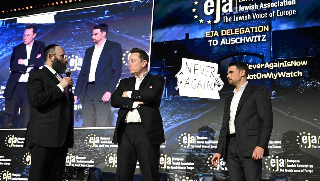 Rabbi Menachem Margolin of the European Jewish Association, Elon Musk and right-wing pundit Ben Shapiro stand on stage at an EJA conference in Krakow, Poland, Jan. 22, 2024. (Courtesy EJA)