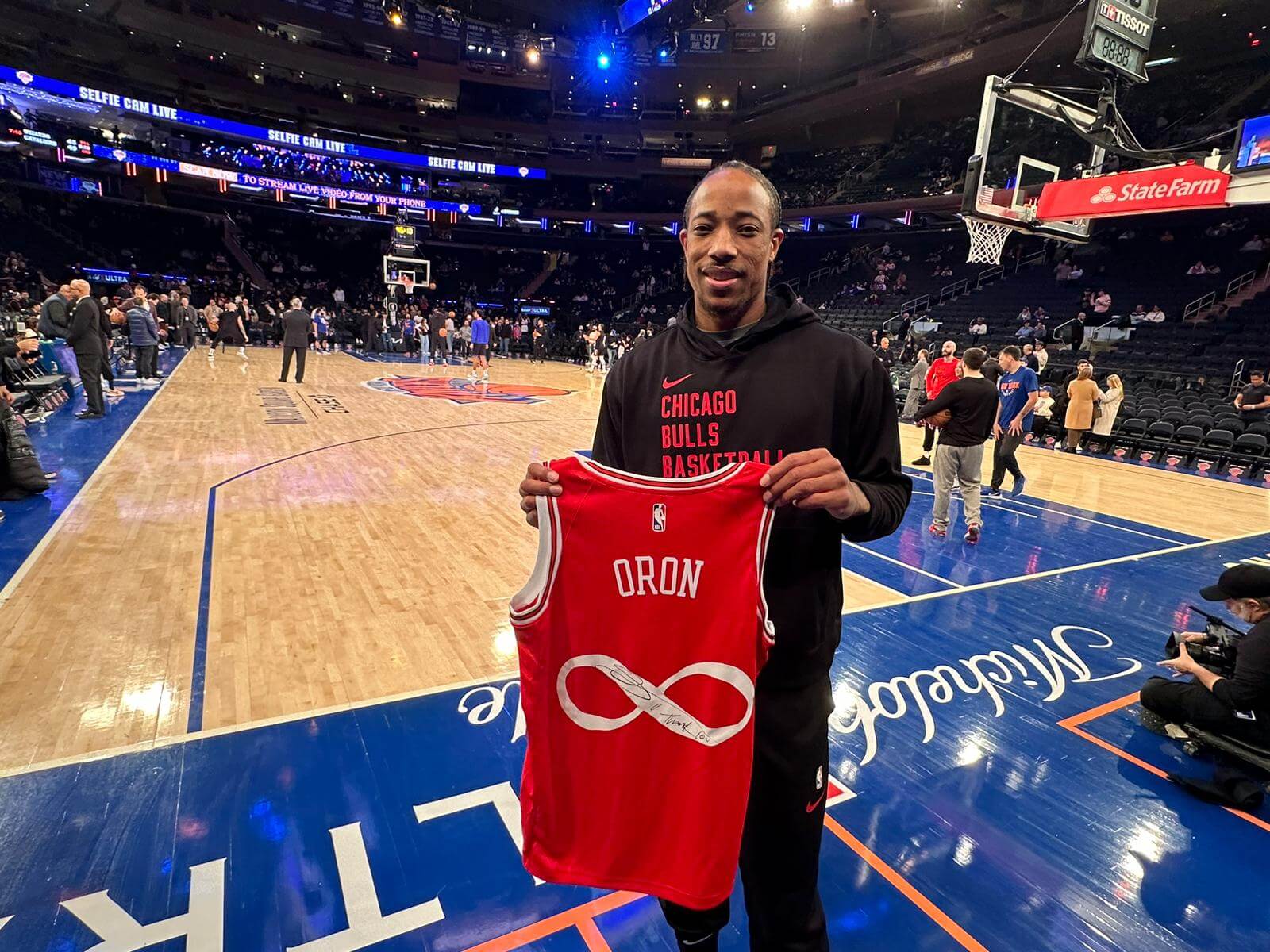 DeMar DeRozan displays the jersey he signed at Madison Square Garden.