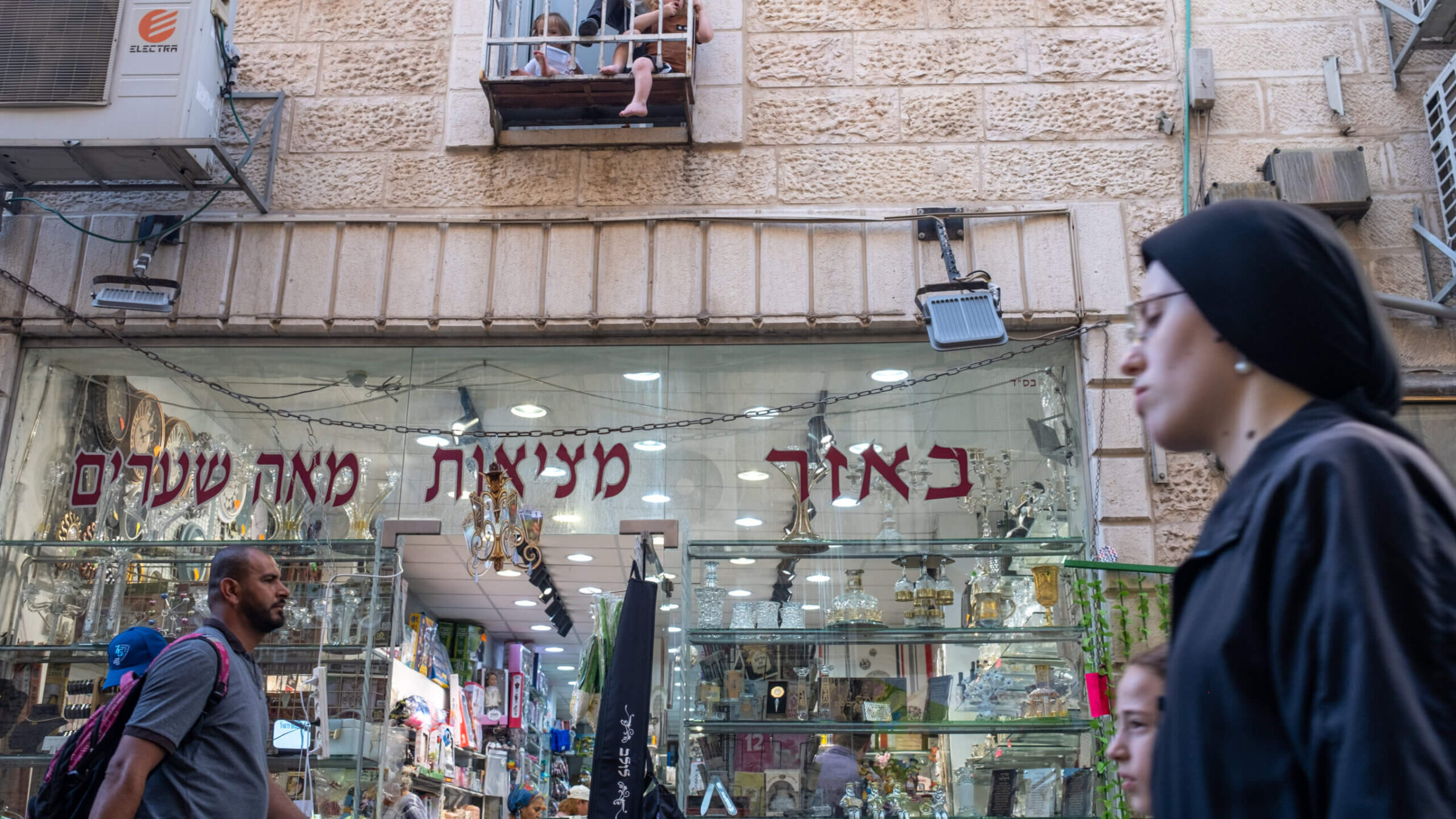 A secular Jewish man and a Haredi woman walk in the Haredi neighborhood of Mea Shearim in Jerusalem, Sept. 27 2023. 