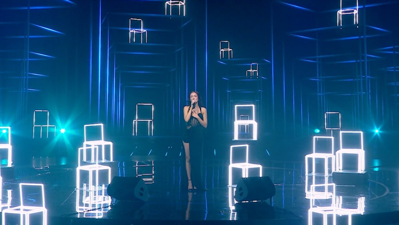 Eden Golan performs an emotional rendition of Aerosmith’s “I Don’t Want to Miss a Thing,” surrounded by empty chairs representing the missing hostages, for her grand finale performance to represent Israel in the 2024 Eurovision Song Contest. (Screenshot via Mako.co.il)