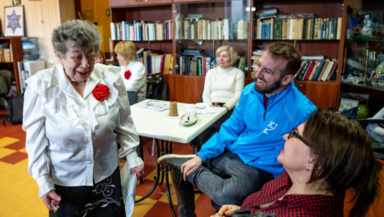 The author (center, in blue) visits with members of the Jewish choir at the American Jewish Joint Distribution Committee’s Hesed social service center in Odesa, Ukraine. They have continued their singing despite the ongoing war. (Arik Shraga)