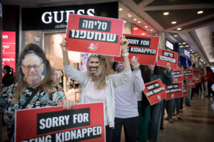 Israelis protest calling for the release of Israeli hostages held by Hamas terrorists in Gaza, at Azrieli Mall in Tel Aviv Feb. 21, 2024. (Miriam Alster/Flash90)