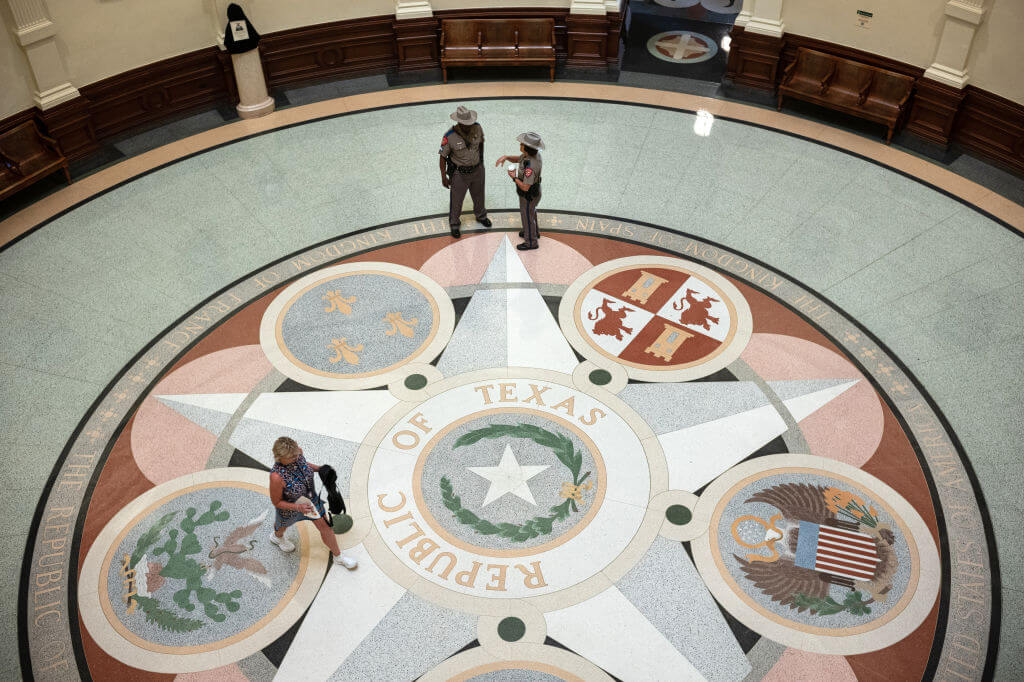 Texas state troopers stand around the lone star in the rotunda of the state capitol in Austin.