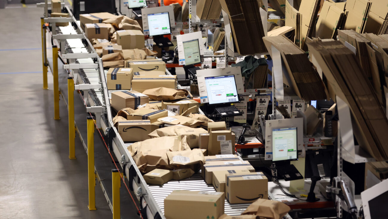 Amazon parcels are prepared at a robotic fullment center. 
