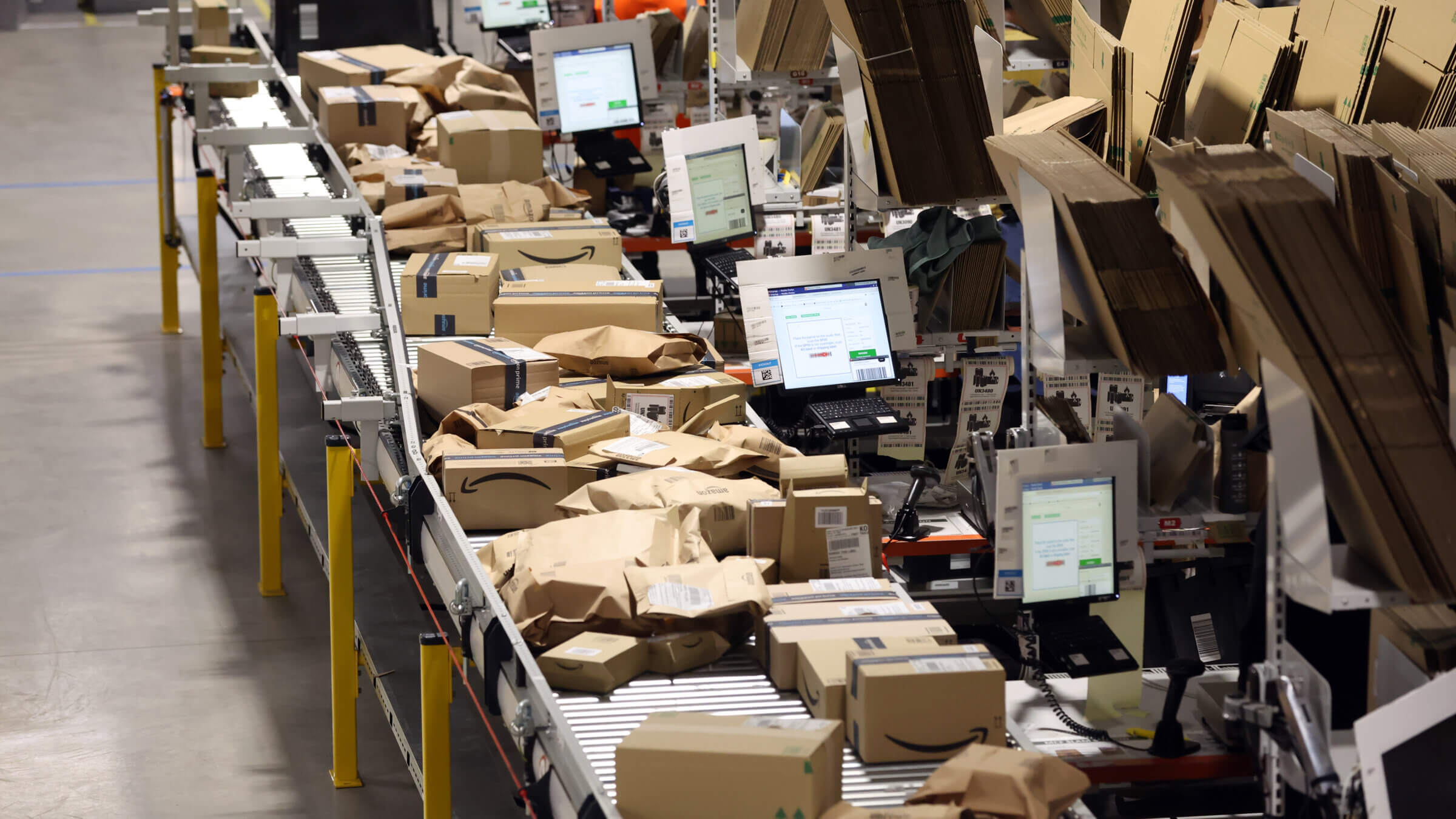 Amazon parcels are prepared at a robotic fullment center. 