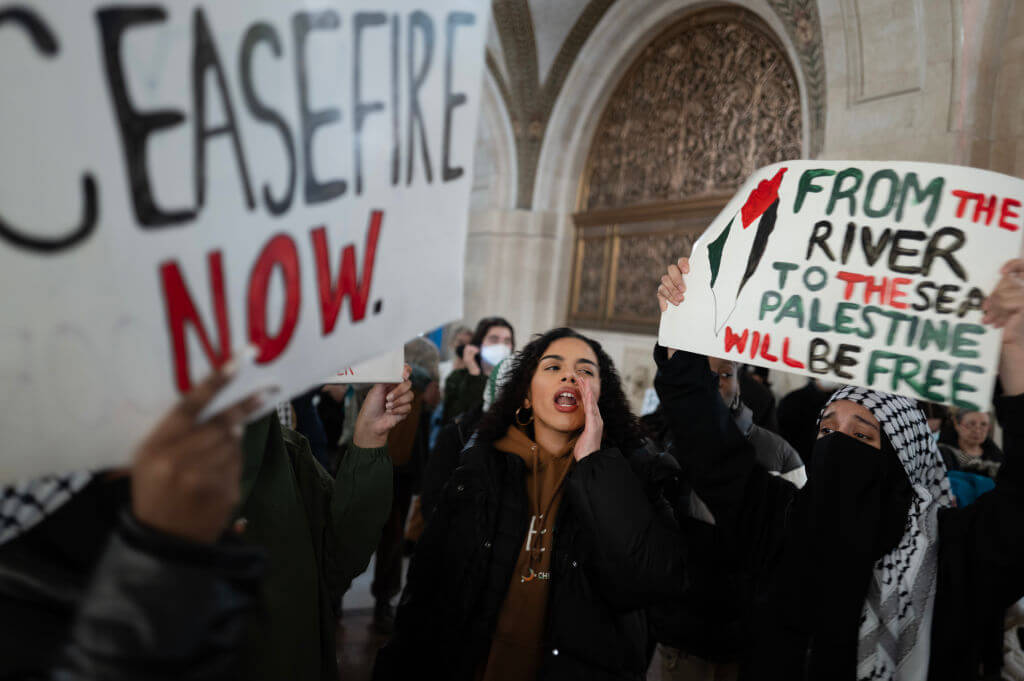Pro-Palestinian demonstrators rally in the lobby of Chicago's City Hall while the city council debates a resolution calling for a cease-fire in the war between Israel and Hamas on January 31, 2024.
