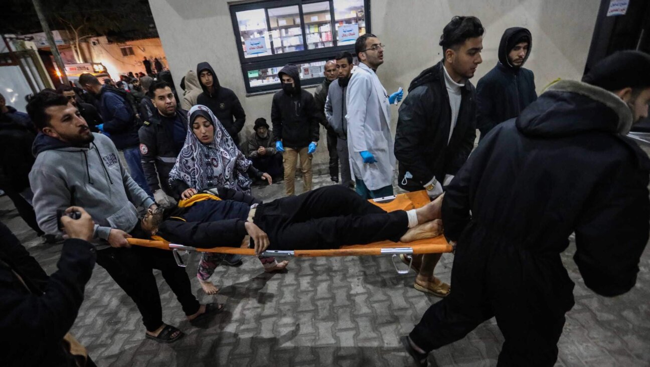 An injured Palestinian is carried to Kuwait Hospital after Israeli air strikes in Gaza on February 12, 2024. 
