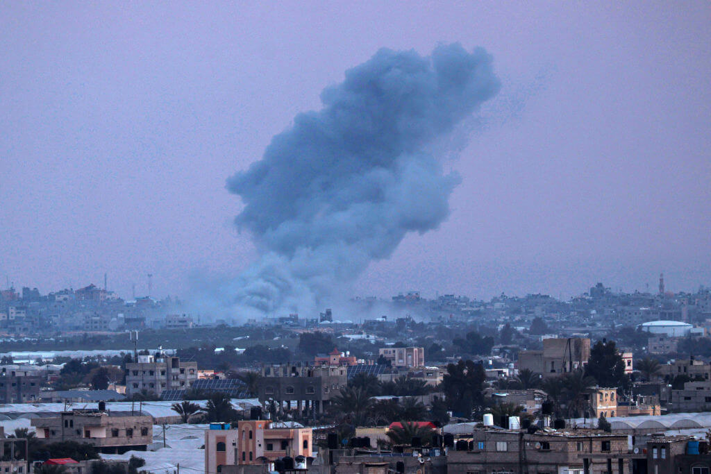 Smoke billows over Khan Yunis in the distance following an Israeli operation in southern Gaza on February 15, 2024.