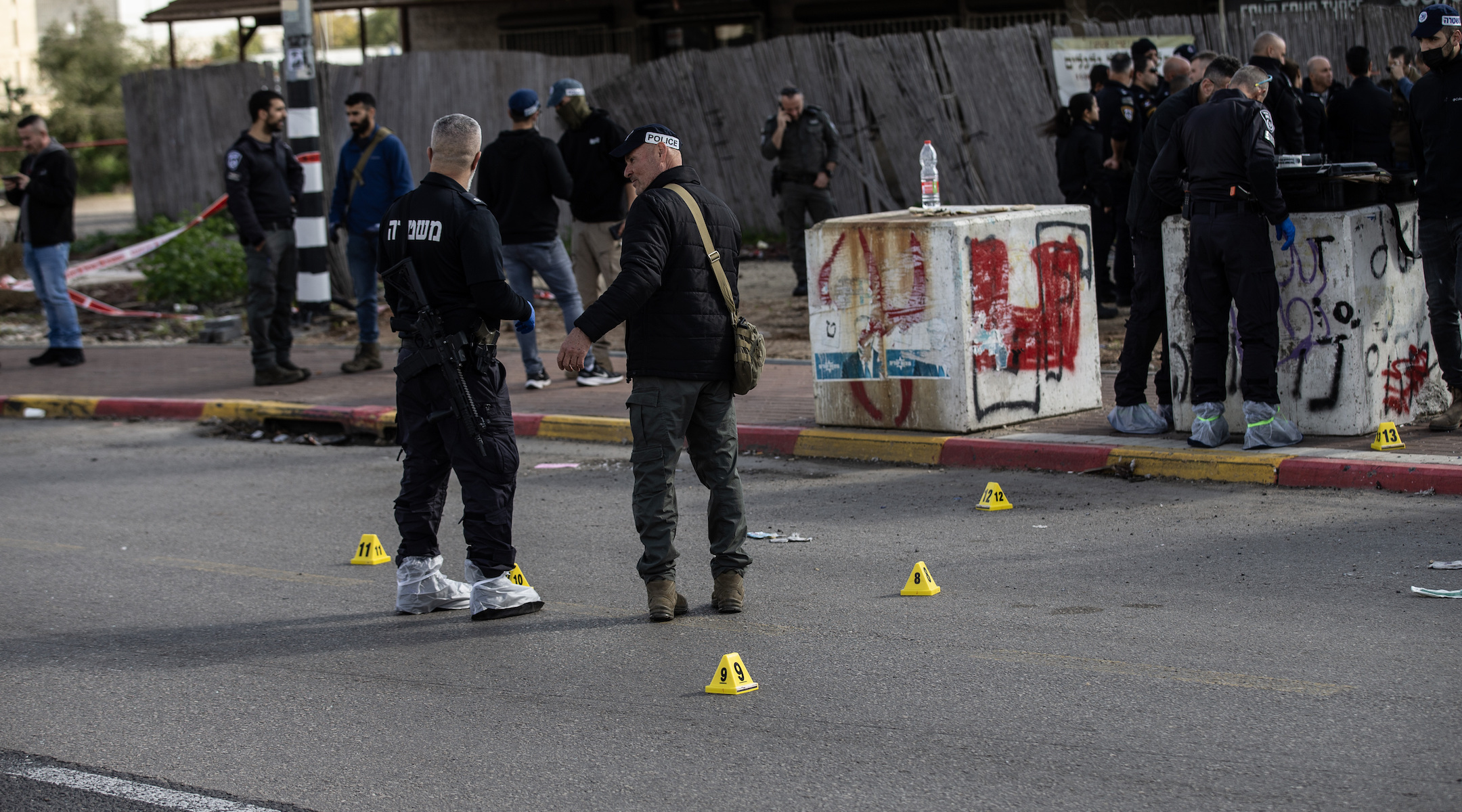 Israeli police investigate the crime scene after a shooting attack on a bus stop in which two people were killed on Feb. 16, 2024. (Mostafa Alkharouf/Anadolu via Getty Images)
