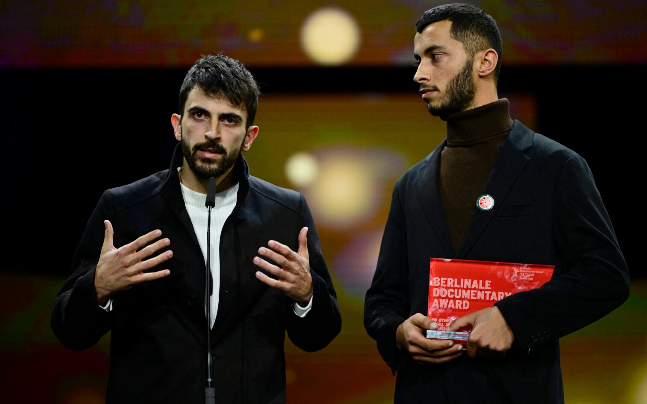 Israeli director Yuval Abraham (L) and Palestinian director Basel Adra speak on stage after having received the Berlinale documentary award for “No Other Land” during the awards ceremony of the 74th Berlinale International Film Festival, Feb. 24, 2024 in Berlin. (John MacDougall/AFP via Getty Images)