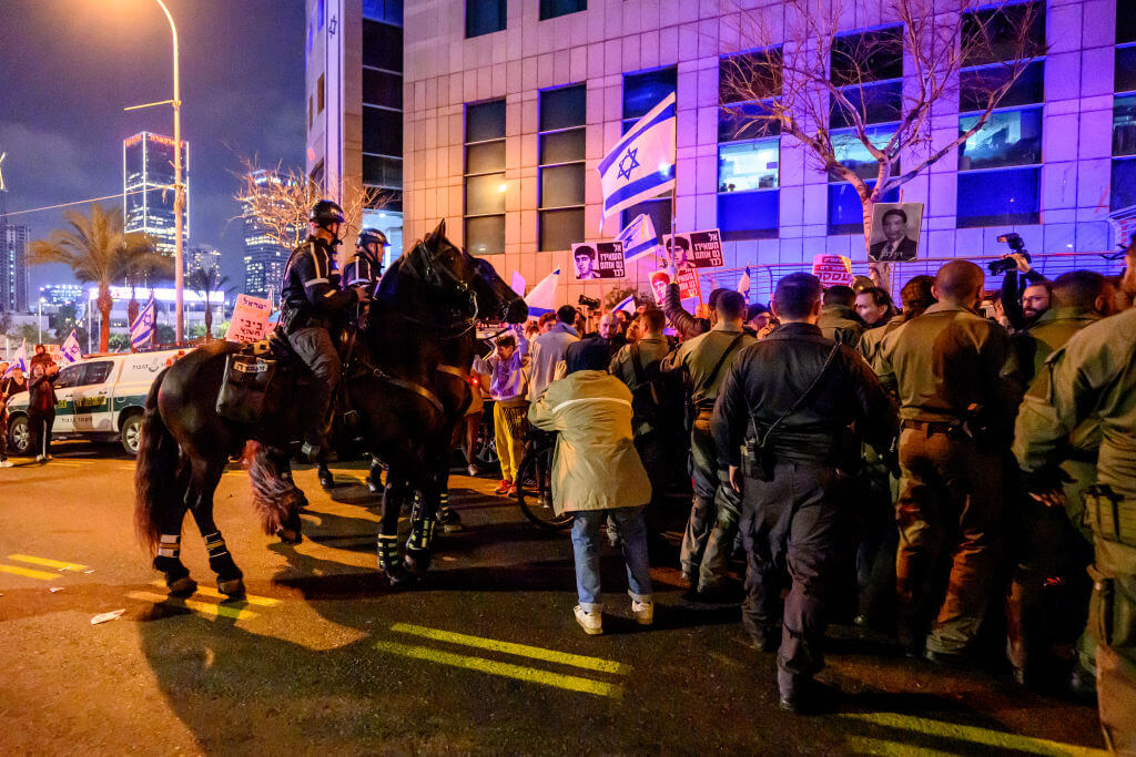 Police on horseback engage protestors on February 24, 2024, outside the IDF's headquarters to demand the resignation of Benjamin Netanyahu and a new election.