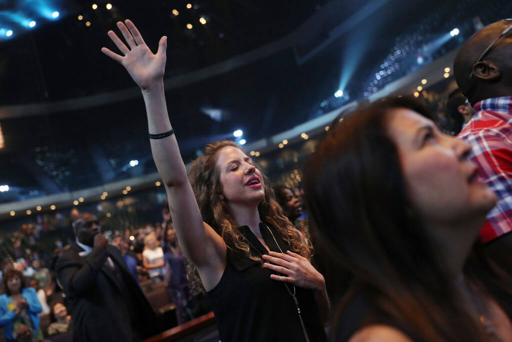 Parishioners of the Lakewood Church in Houston, led by Pastor Joel Osteen, pray.