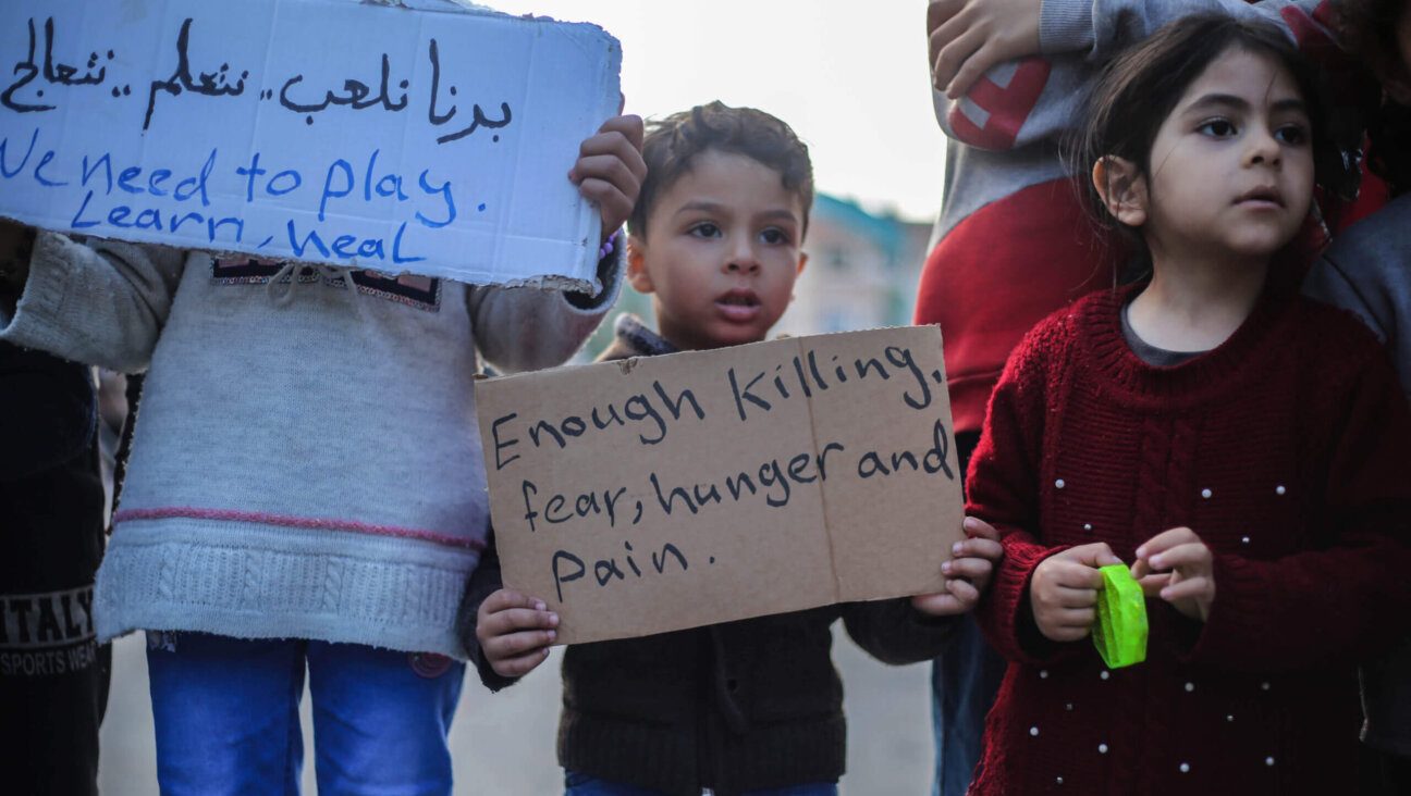 Palestinian children hold placards during a march demanding an end to the war, Feb. 14, in Rafah, Gaza. 