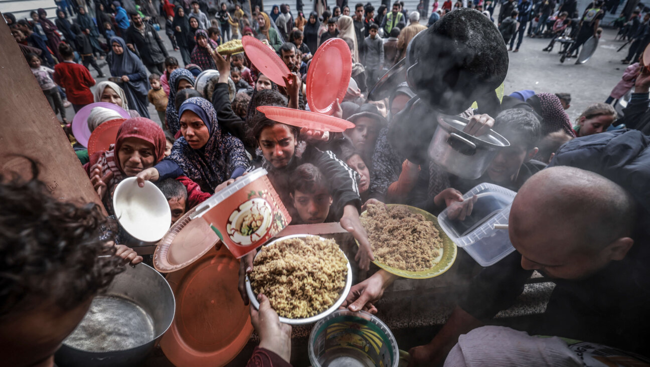 Displaced Palestinians gather to receive food at a government school in Rafah, Gaza, Feb. 19.