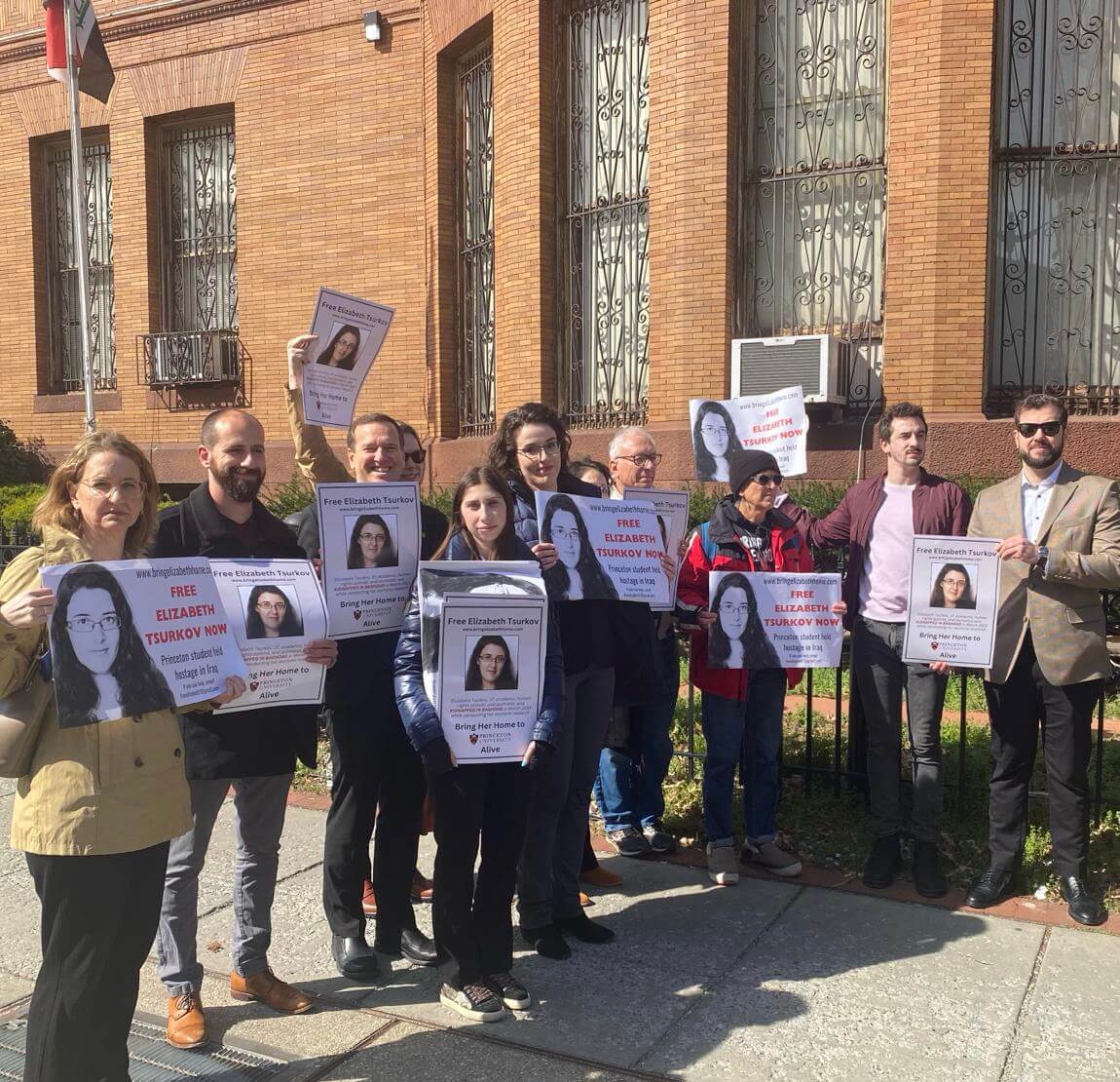 Supporters of Elizabeth Tsurkov, an academic kidnapped in Iraq a year ago, held a rally at the Iraqi Embassy in Washington, Mar. 21, 2024.  Her sister Emma is standing center, with glasses.