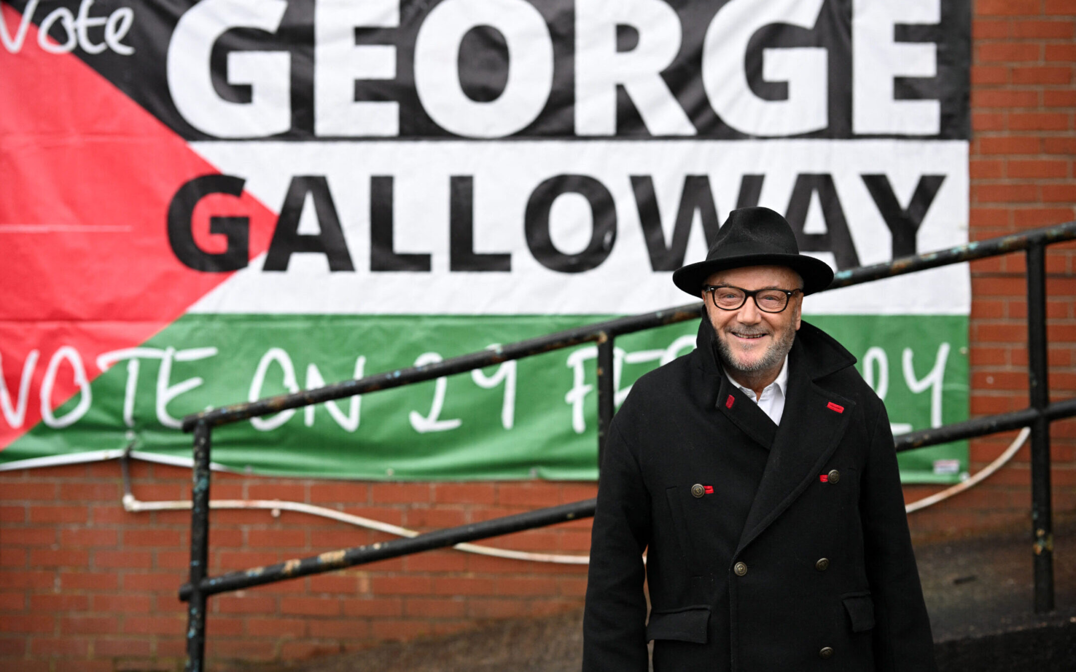 The new Workers Party Member of Parliament for Rochdale, George Galloway, poses for a photograph outside his campaign headquarters in northern England on March 1, 2024, after a campaign that focused on Gaza. (Oli Scarff/AFP via Getty Images)