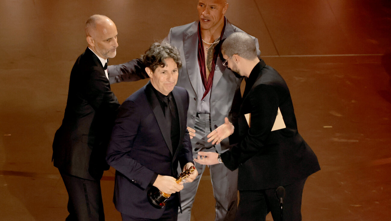 Jonathan Glazer, with producers Leonard Blavatnik and James Wilson, accepts the Oscar for Best International Film.