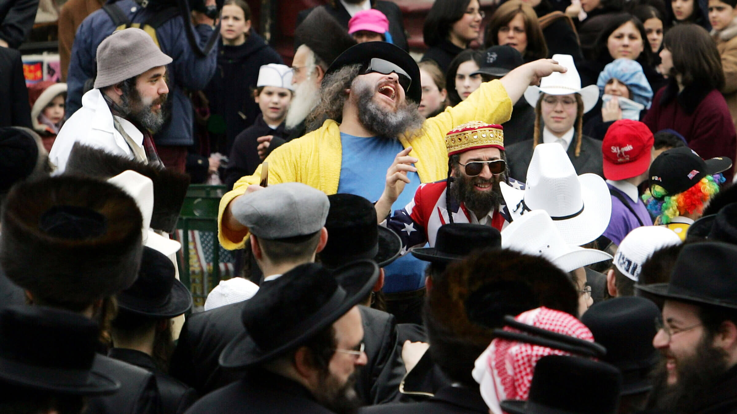 NEW YORK - MARCH 25:  Jews dance in costumes and cowboy hats during Purim festivities in the Williamsburg section of Brooklyn in 2005. 