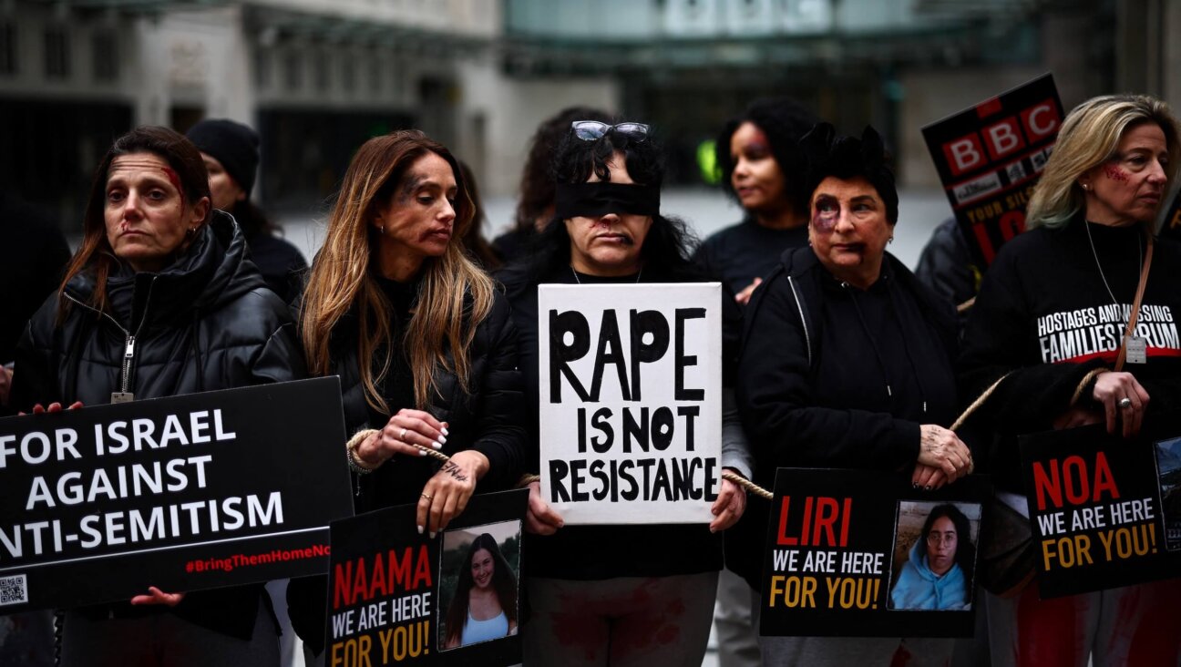 Protesters wearing fake blood makeup and holding placards take part in a demonstration outside BBC headquarters in London on Feb. 4.
