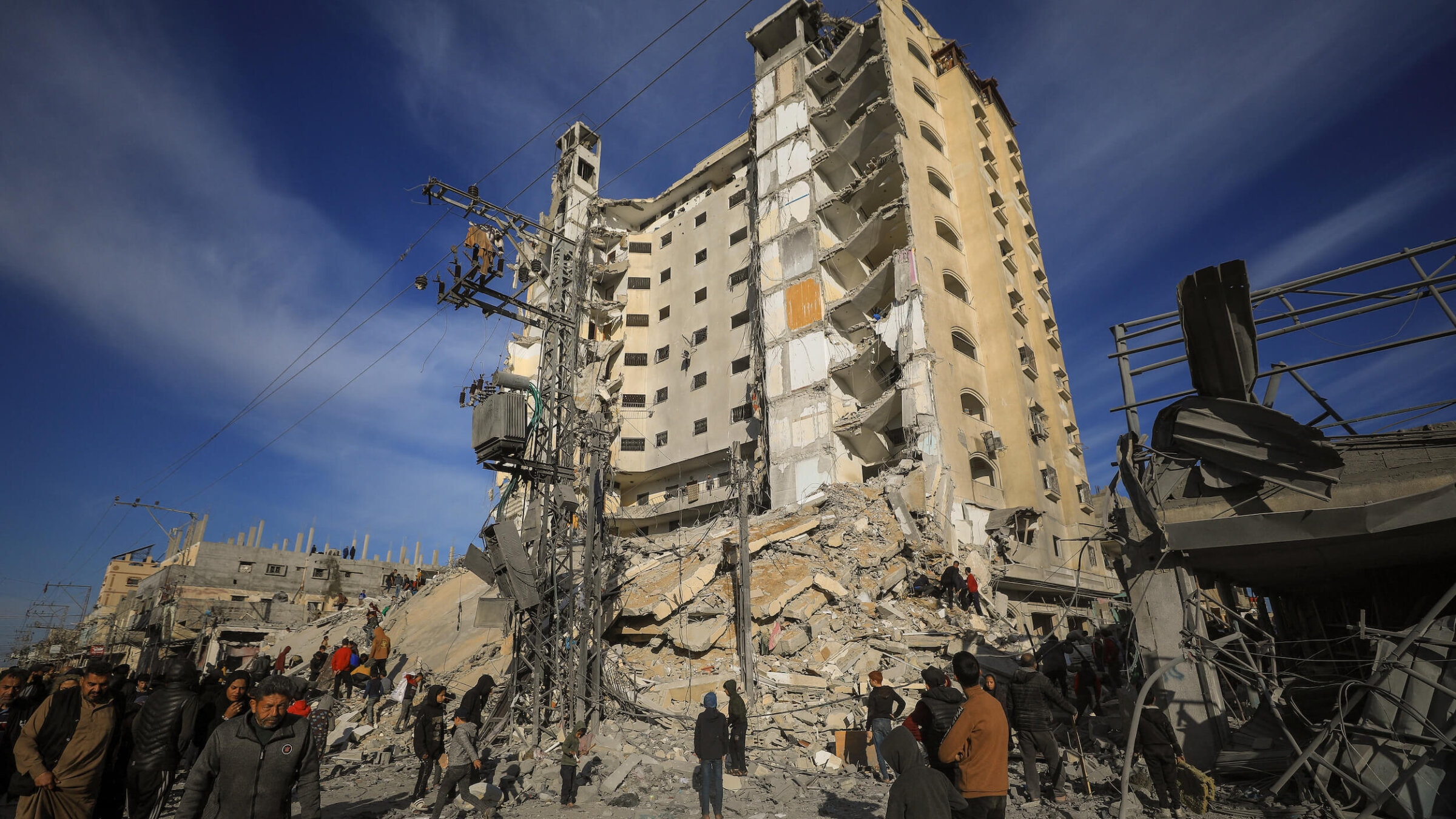 Palestinians gather in front of a residential building hit in an overnight Israeli air strike in Rafah in the southern Gaza Strip on March 9. 