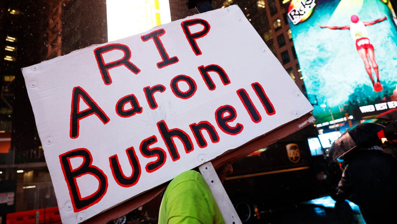 A person holds a sign during a vigil for Aaron Bushnell at the U.S. Army Recruiting Office in Times Square on Feb. 27, 2024.  