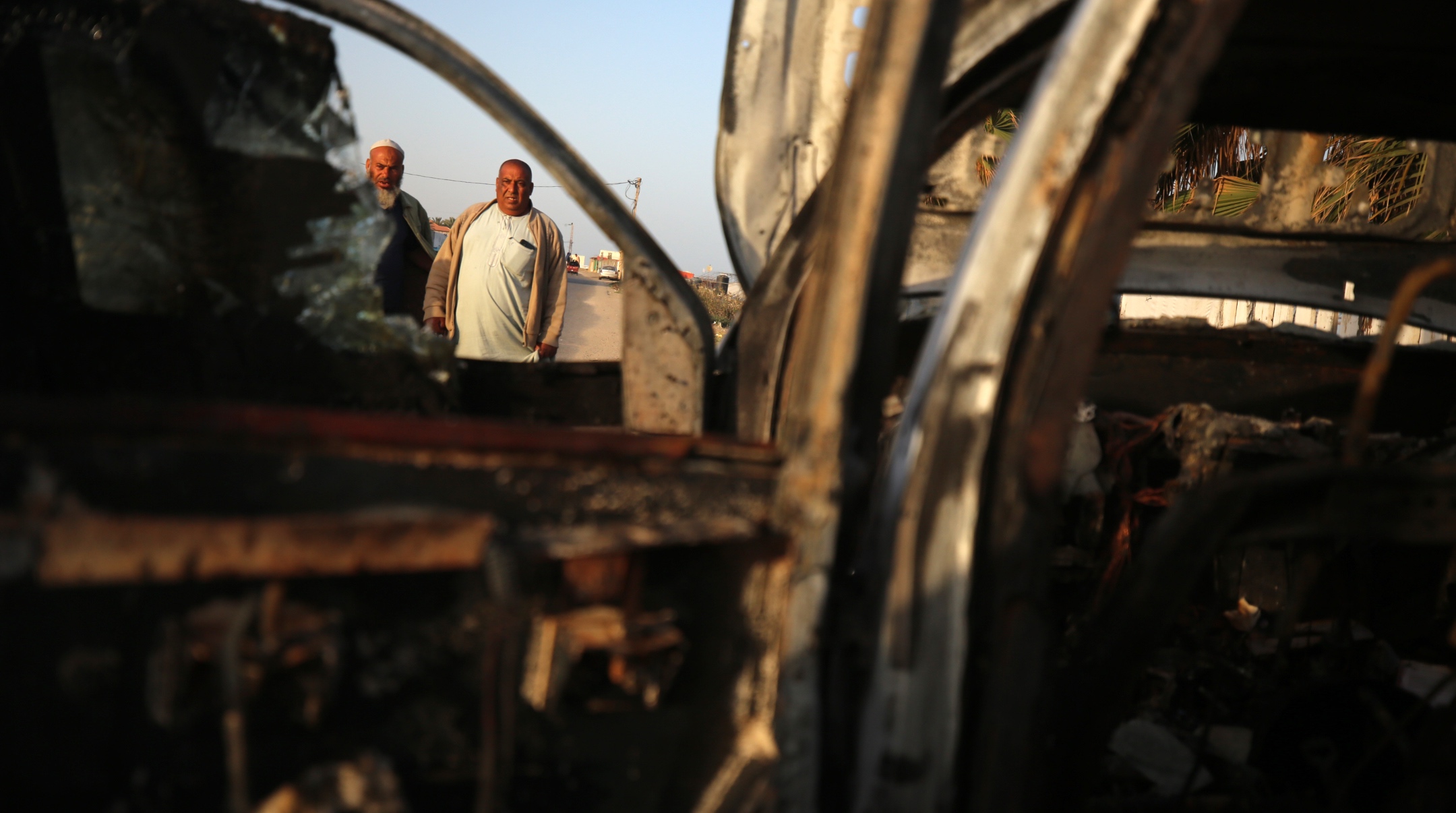 Palestinians stand next to a vehicle, where volunteers from the World Central Kitchen, including foreigners, were killed in an Israeli airstrike, according to the NGO, in Deir Al-Balah, in the central Gaza Strip, April 2, 2024. (Majdi Fathi/NurPhoto/Getty Images)