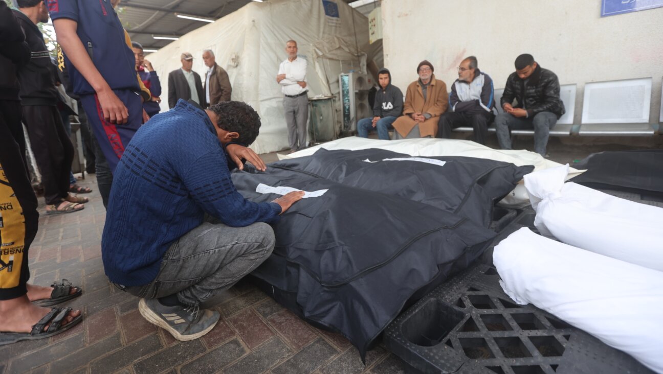 Relatives of Palestinians killed during an Israeli attack on the Abu Diraz family home mourn as their bodies are taken from Al-Najjar hospital morgue for burial in Rafah, Gaza, April 04, 2024. (Ahmed Zaqout/Anadolu via Getty Images)