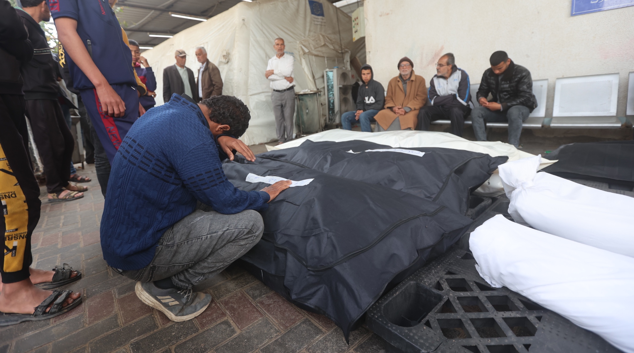 Relatives of Palestinians killed during an Israeli attack on the Abu Diraz family home mourn as their bodies are taken from Al-Najjar hospital morgue for burial in Rafah, Gaza, April 04, 2024. (Ahmed Zaqout/Anadolu via Getty Images)