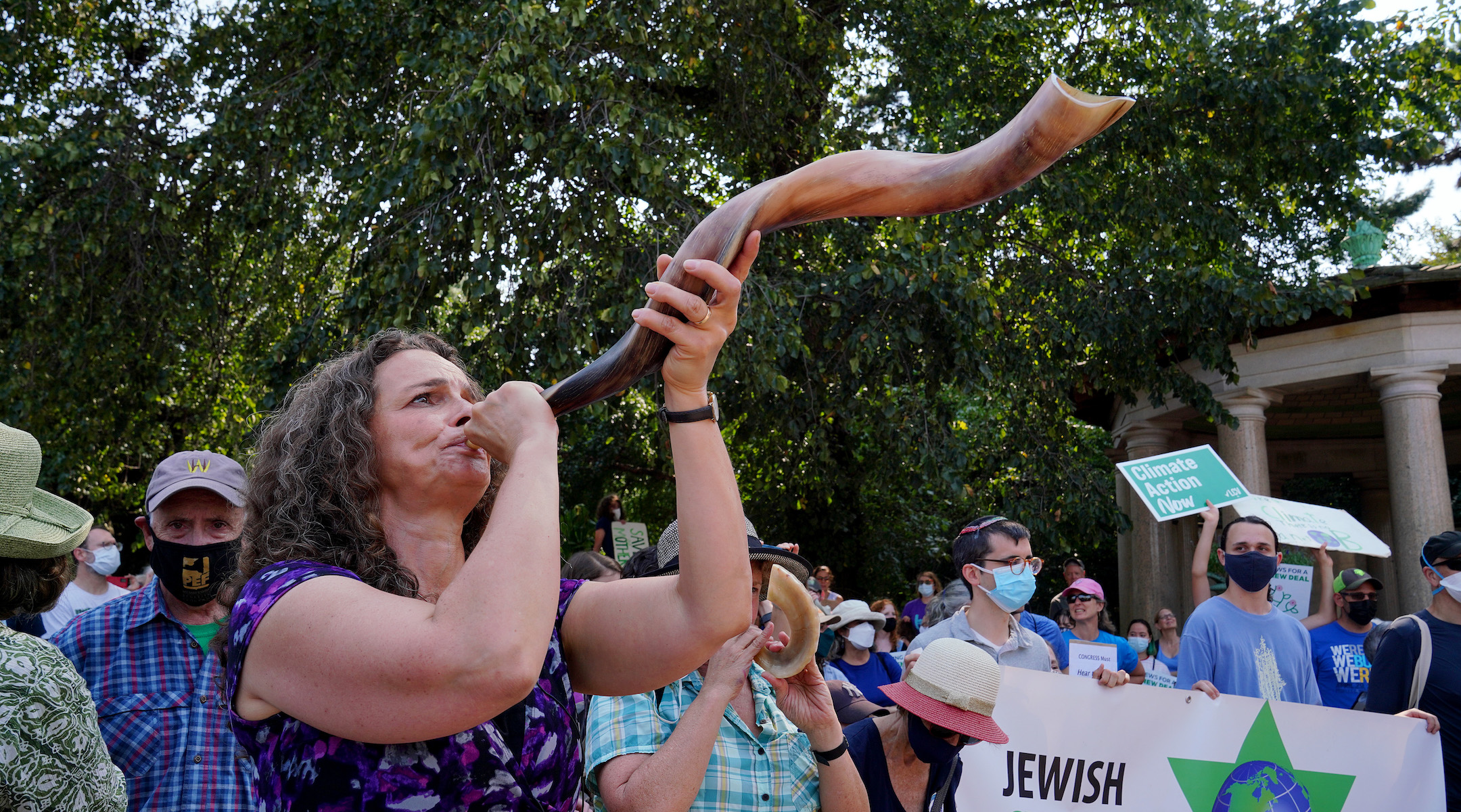 Rabbi Jennie Rosenn blows the shofar at the “Jewish Climate Action, Hear The Call Senator Schumer” event in New York City on September 12, 2021. (Jemal Countess / Getty, courtesy of Dayenu)