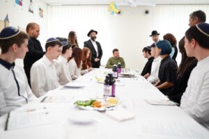 Ukrainian President Volodymyr Zelensky sits with students from the Simcha School in Kyiv for a model Passover seder, April 18, 2024. (Courtesy FJCU)