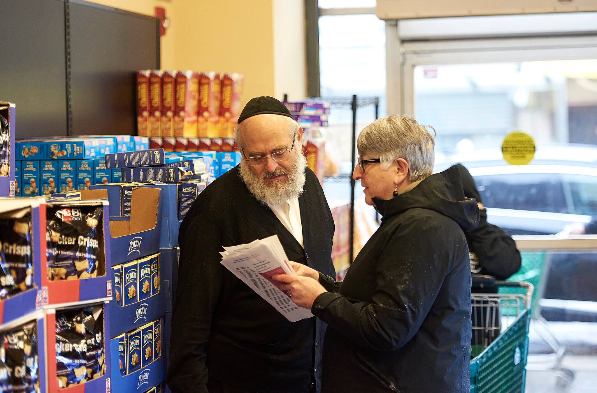 A volunteer with Jews For Racial and Economic Justice speaks about community safety at a New York grocery store in February 2020. The group asked lawmakers this week not to expand the Nonprofit Security Grant Program.