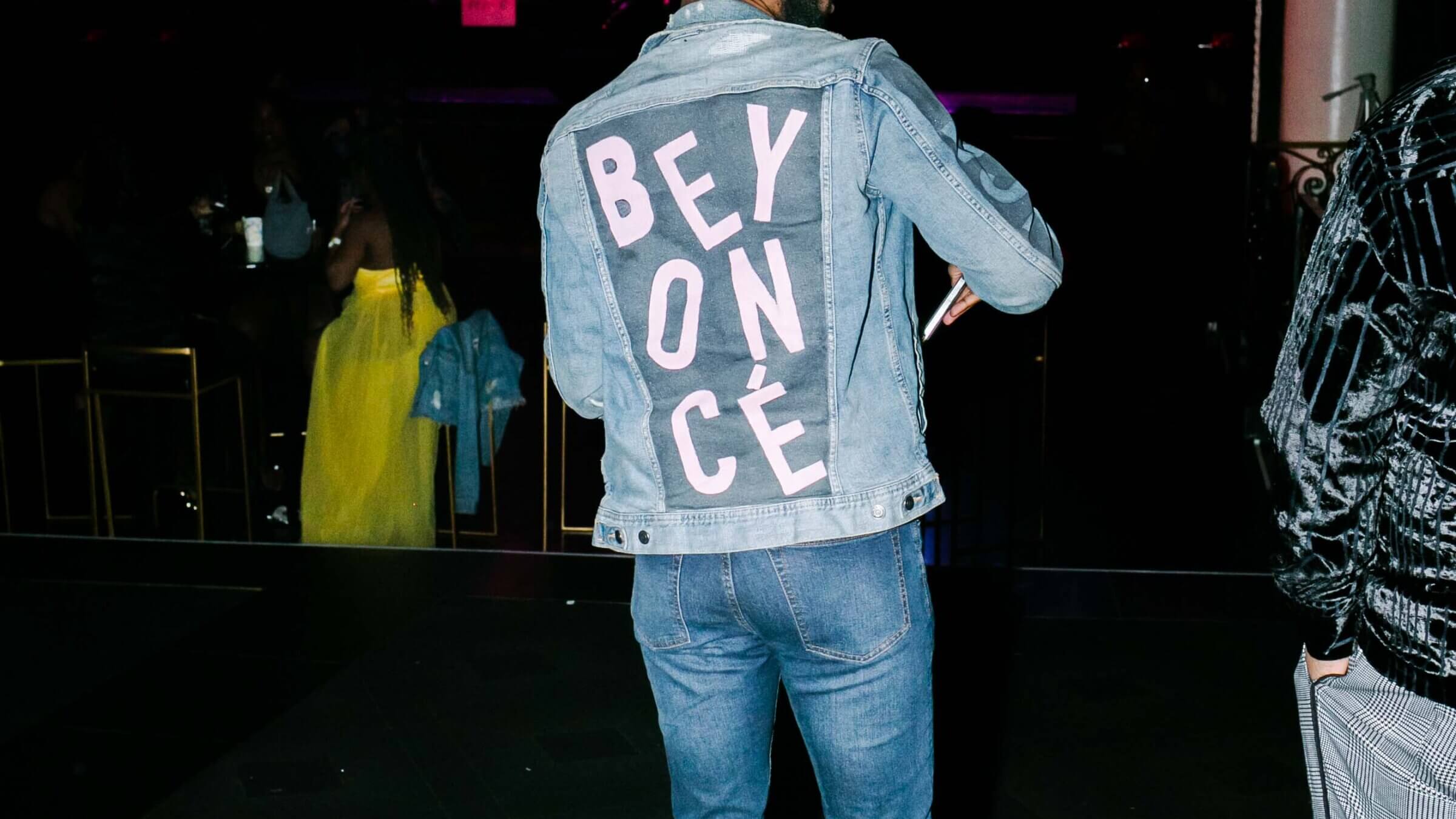 A member of the Bey Hive wears a denim jacket with Beyoncé's name.