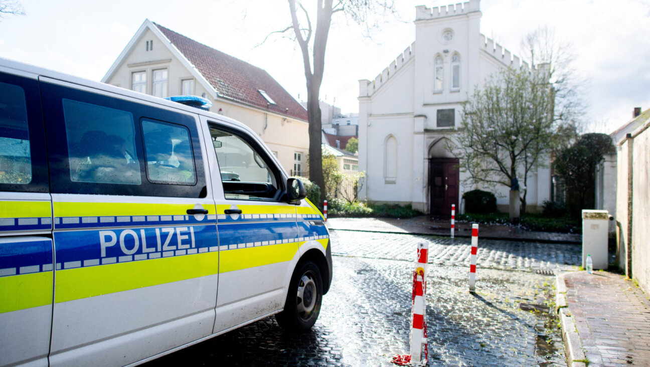 A police vehicle stands in front of the synagogue in the city center of Oldenburg, Germany, after an incendiary device was thrown at its door. (Hauke-Christian Dittrich/dpa via Getty Images)