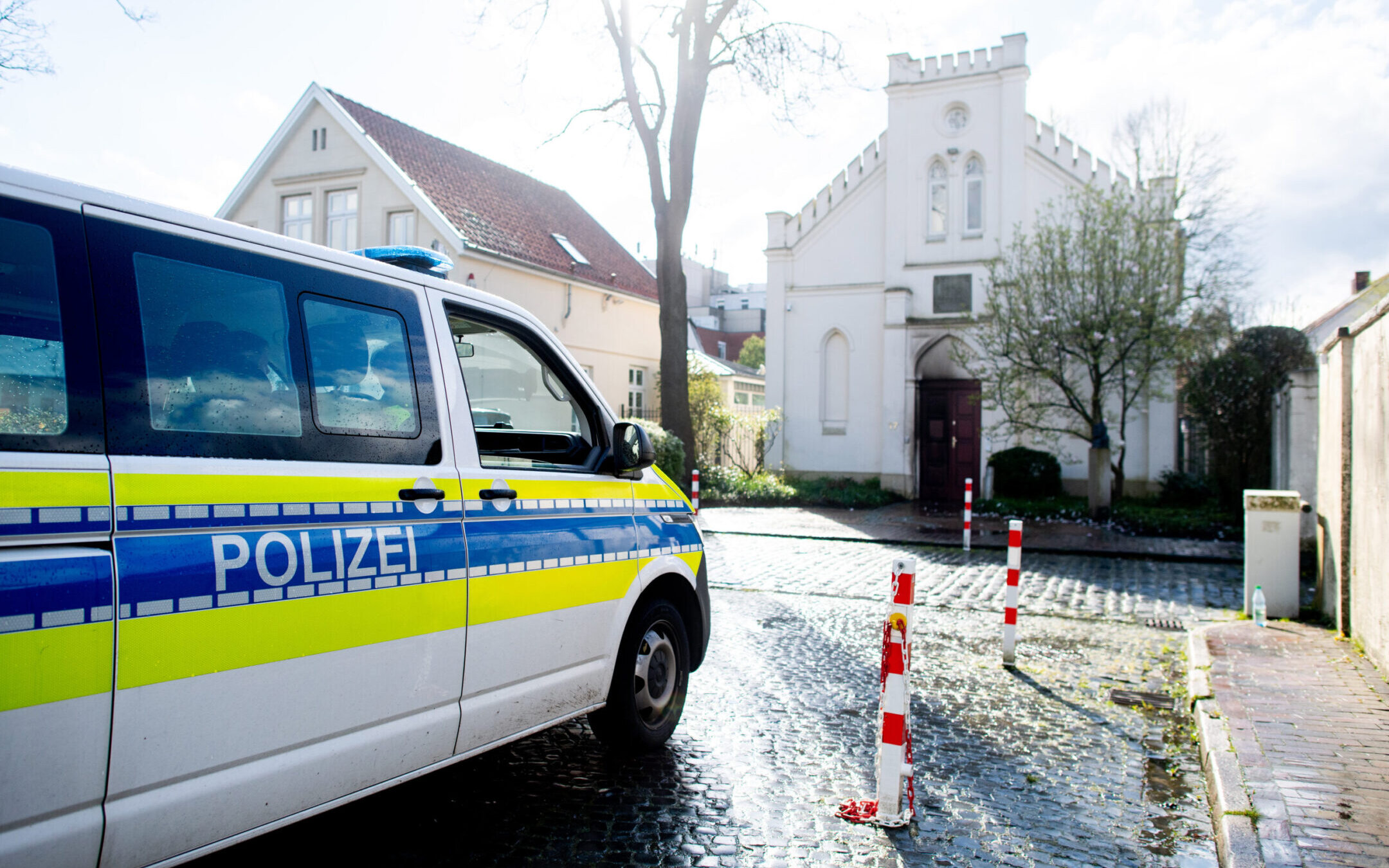 A police vehicle stands in front of the synagogue in the city center of Oldenburg, Germany, after an incendiary device was thrown at its door. (Hauke-Christian Dittrich/dpa via Getty Images)